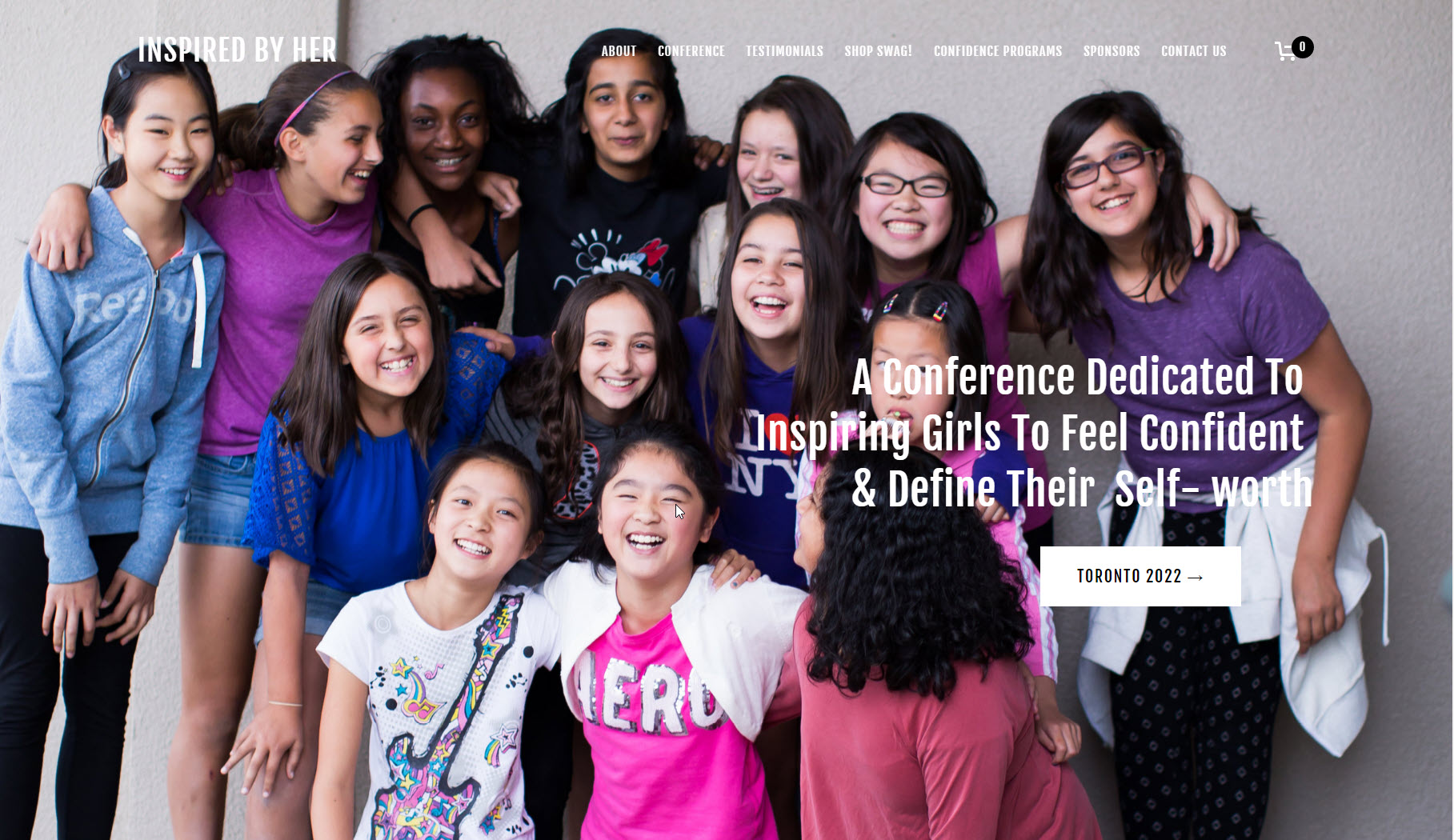 Inspired by Her Conference Hero Image - roughly twenty girls ages 8-14 posing for a group photo